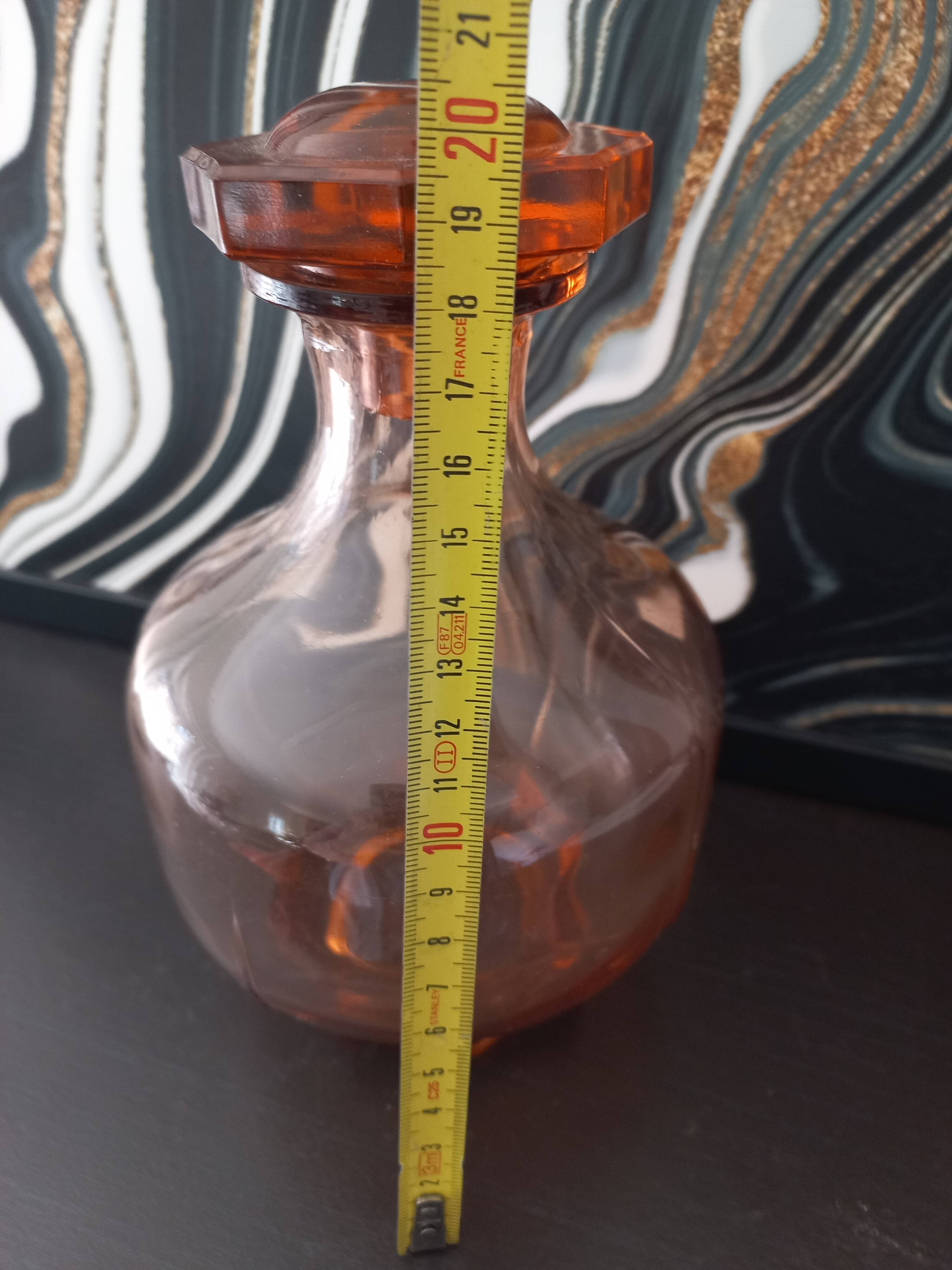Vintage glass carafe in pink-orange, retro-chic style.