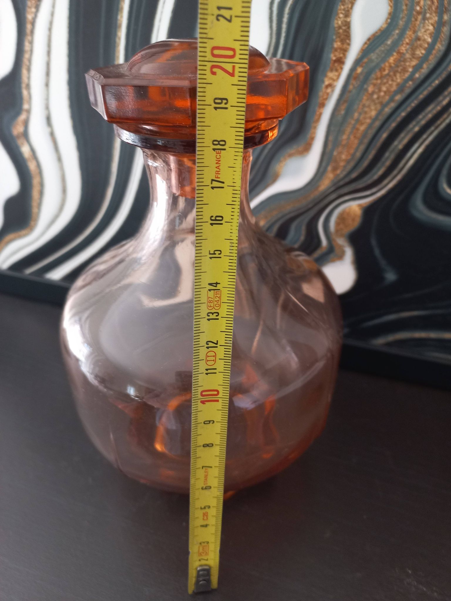 Vintage glass carafe in pink-orange, retro-chic style.