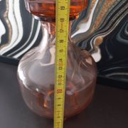 Vintage glass carafe in pink-orange, retro-chic style.