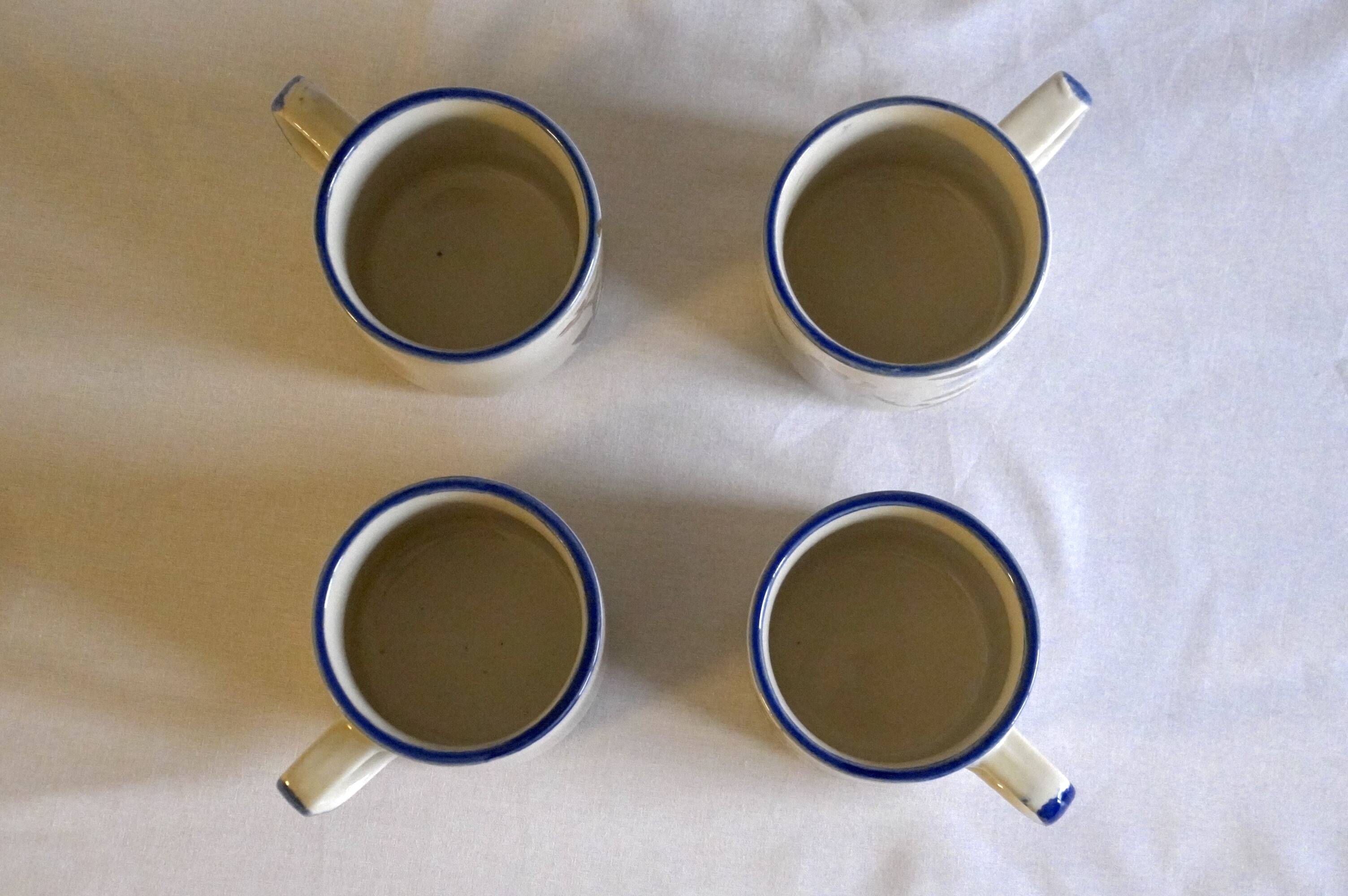 Set of 4 stoneware cups/mugs with blue floral designs, made in China.