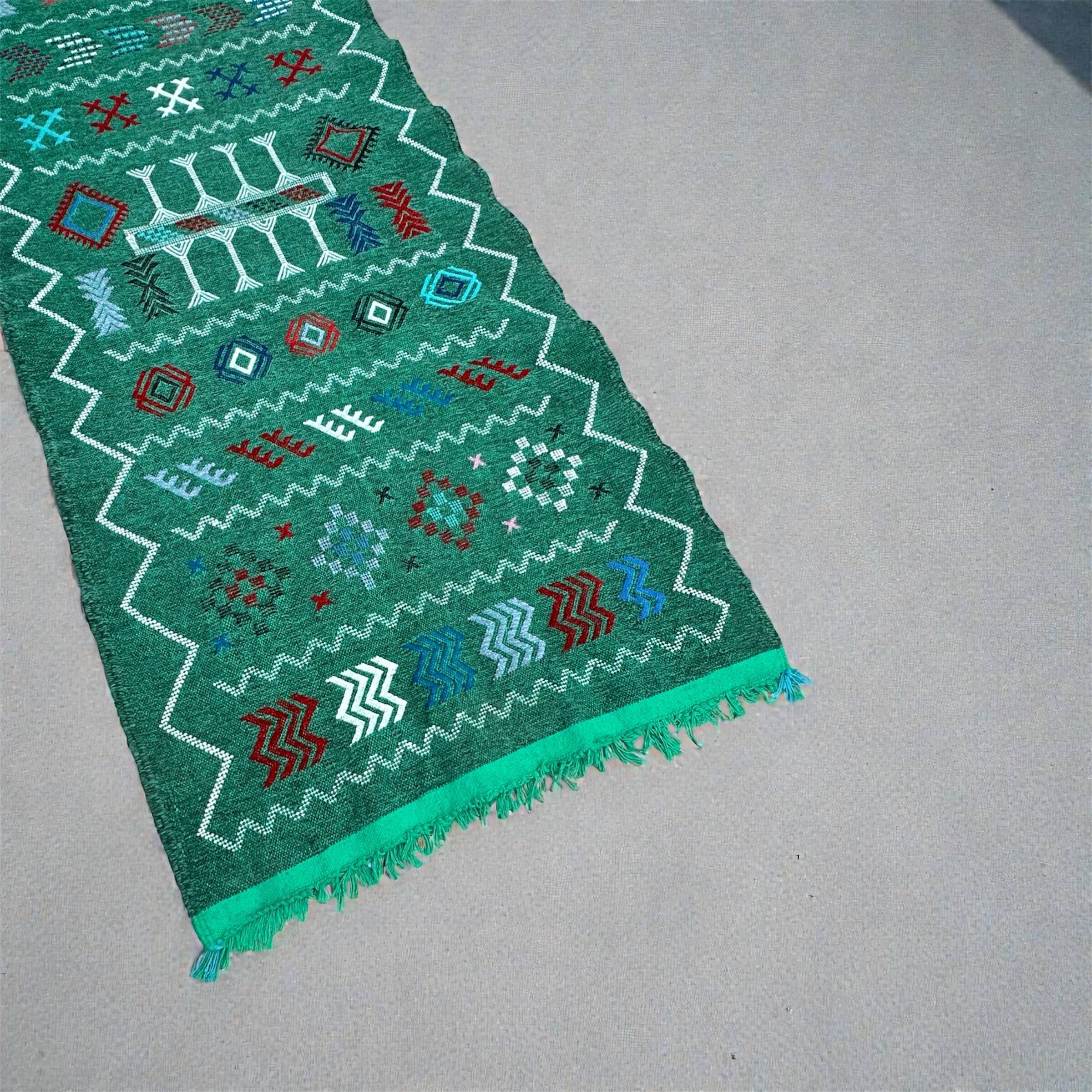 Handwoven green Moroccan hallway rug with geometric patterns.