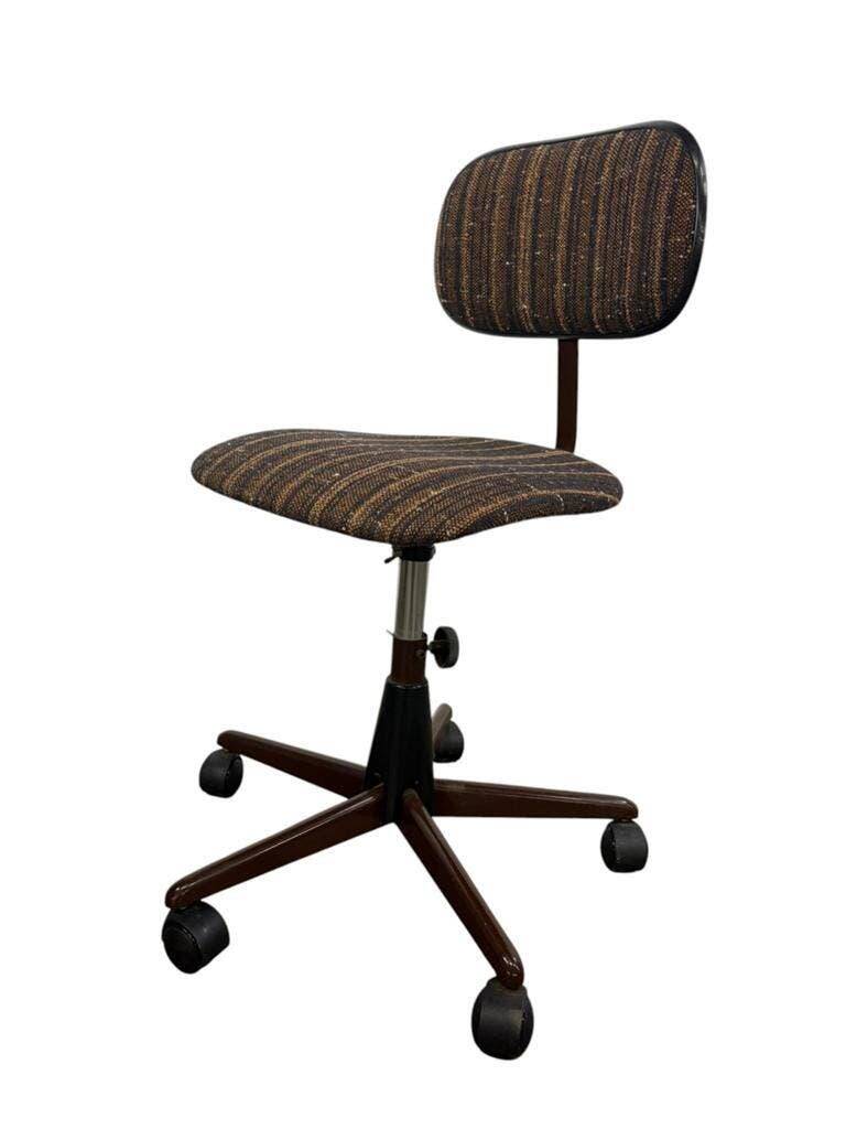 Brown vintage office chair from the 70s on wheels.