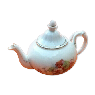 Old porcelain teapot with floral decoration