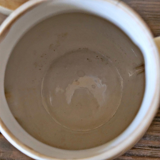 Vintage round ceramic teapot in cream colour, art deco style.