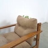Brown-grey armchair with an oak frame.