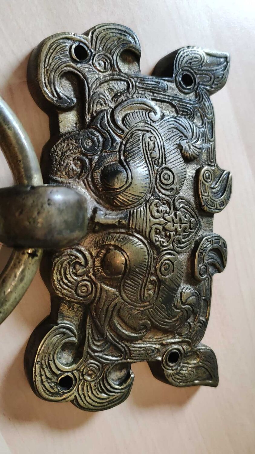 Ancient door knocker, taotié mask, shang dynasty. in bronze golden patina