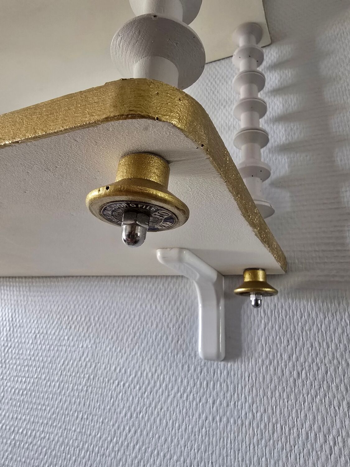 White and gold spool shelf