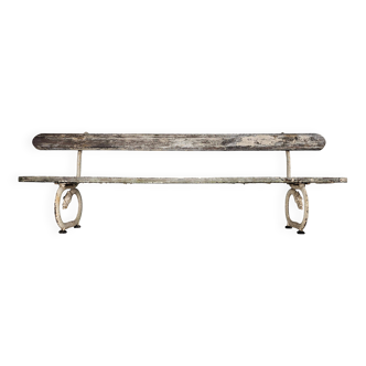 French garden bench from the early 1900s with dragons and arrows.