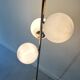 Cluster floor lamp with 3 spherical lamps in gold metal and white glass