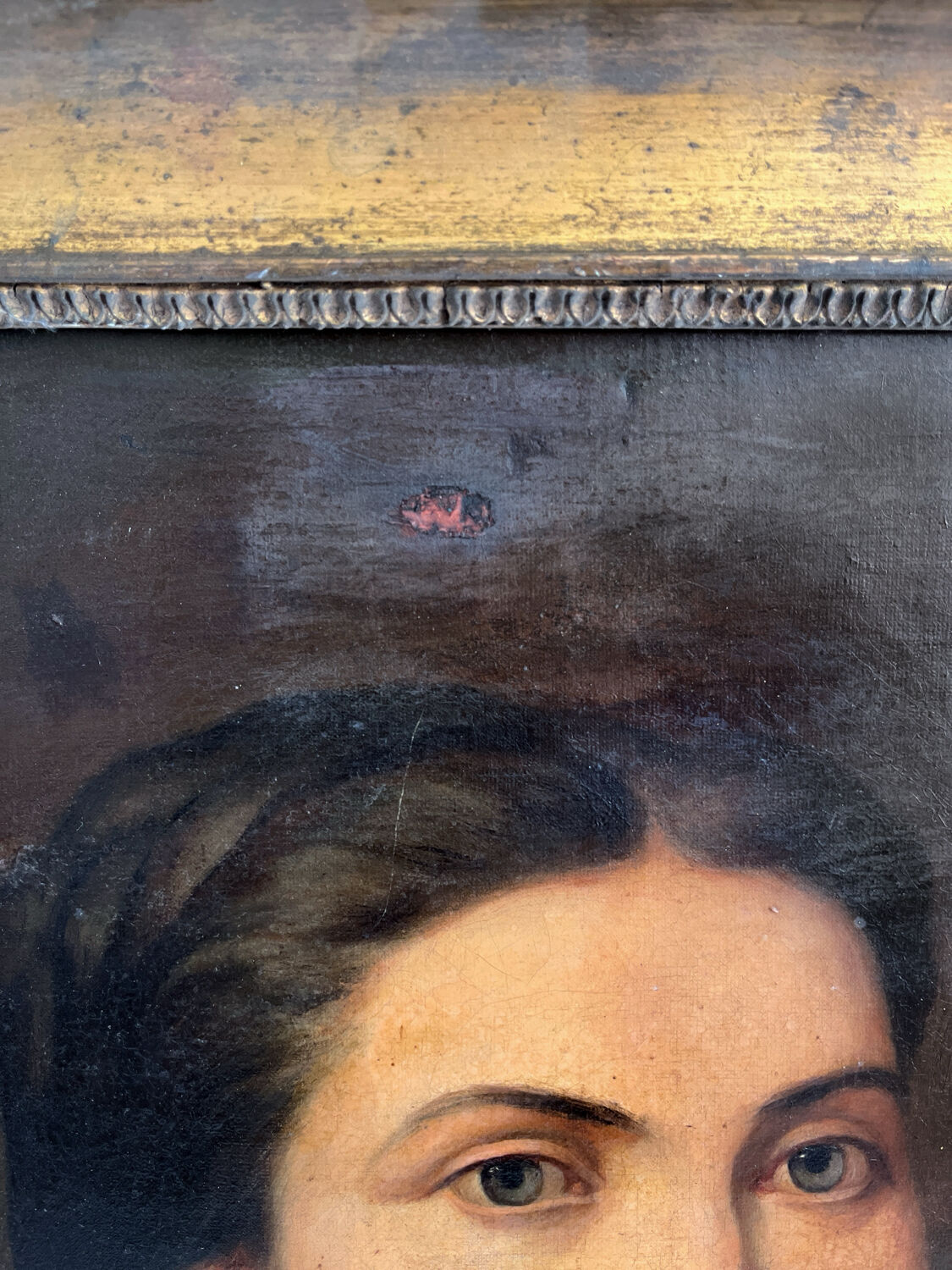 Old oil painting on canvas portrait of a woman with a red bow, late 19th century