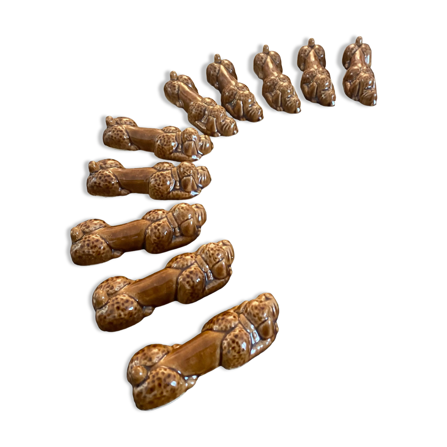 10 ceramic knife holders in the shape of a recumbent poodle