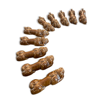 10 ceramic knife holders in the shape of a recumbent poodle