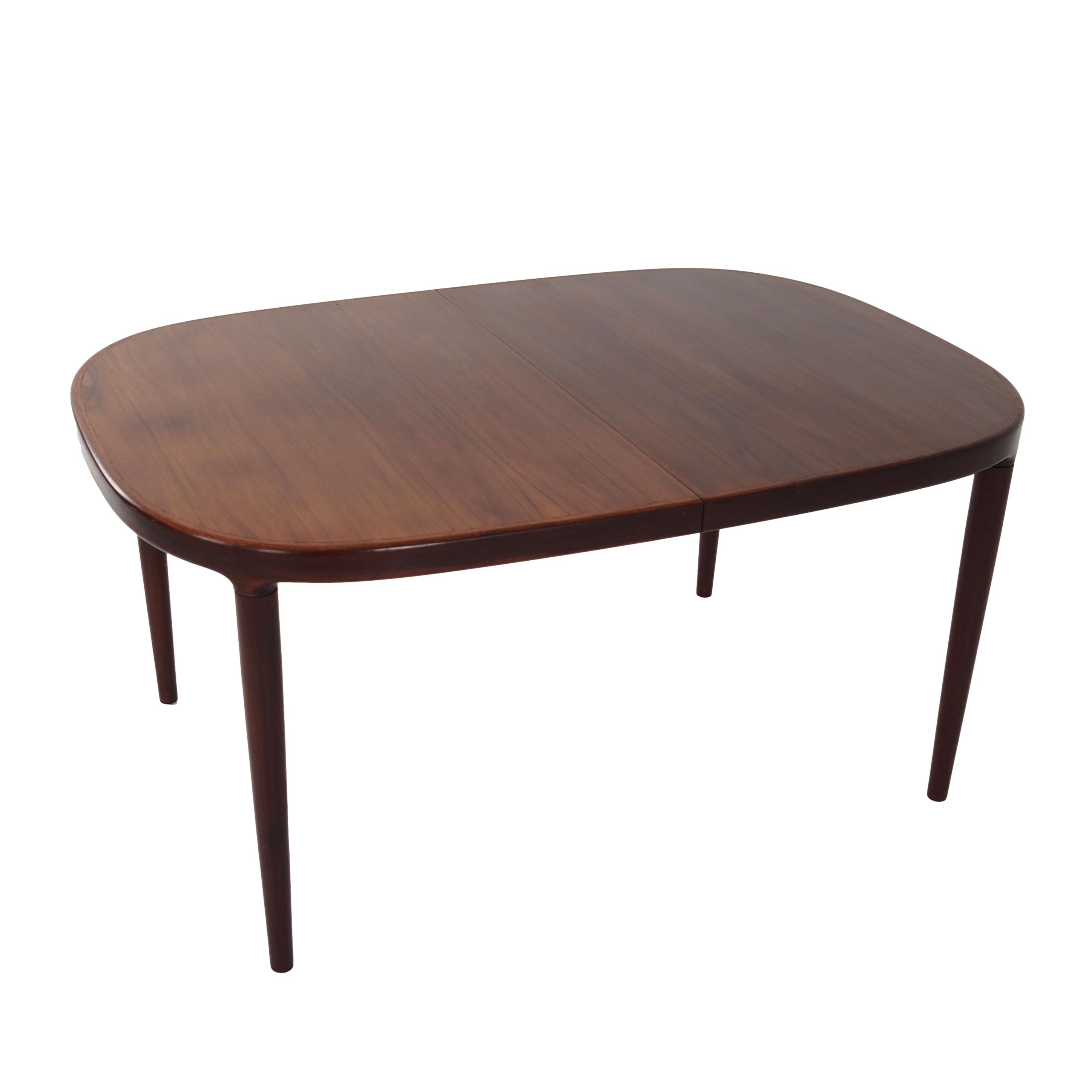 Oval table, covered with rosewood veneer.Design of the 70s