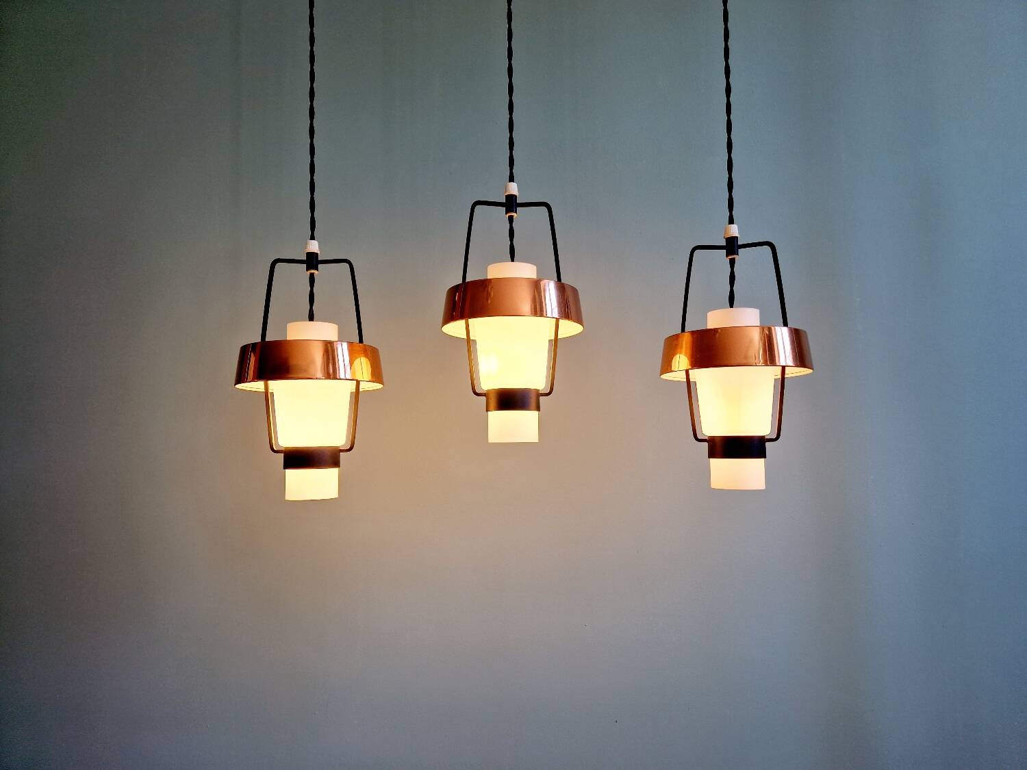 Trio of Scandinavian pendant lights in opaline and copper metal, 1960s