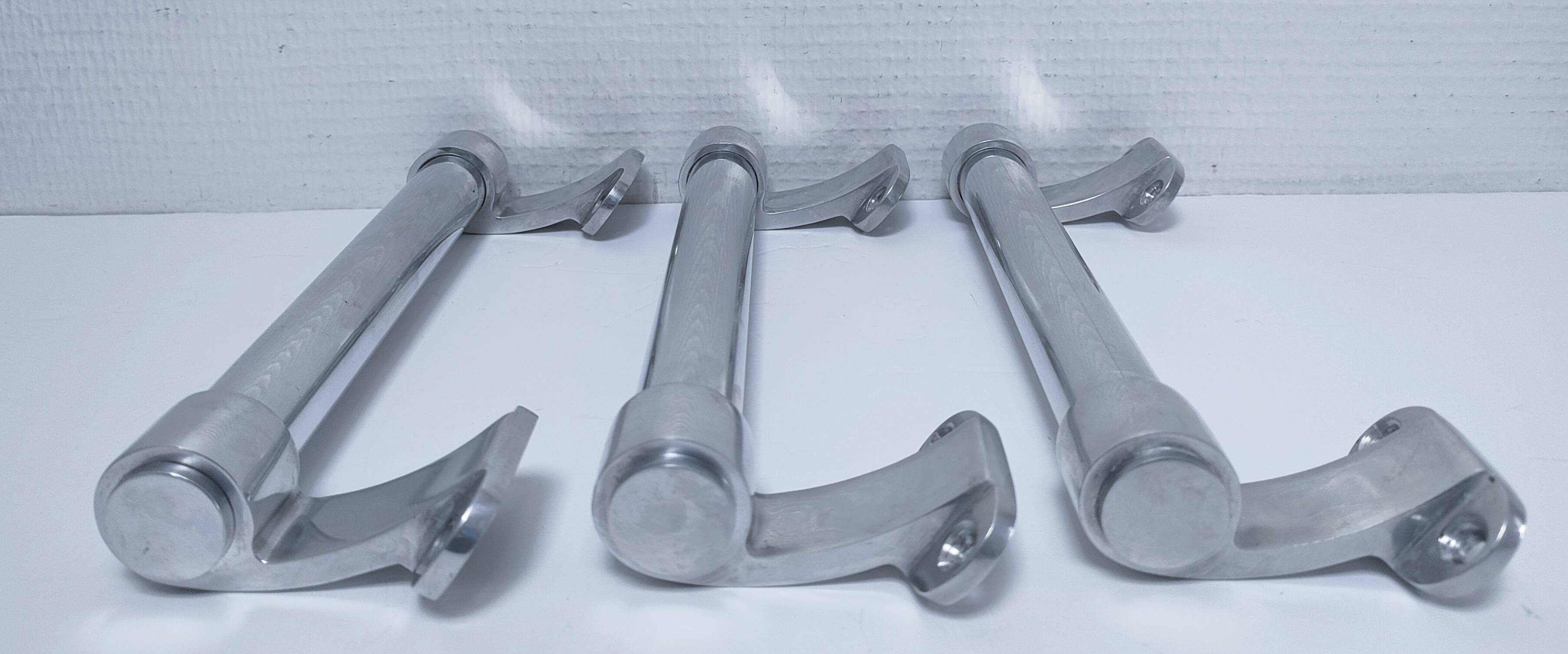 three long aluminum shop handles from the mid-20th century