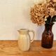 Vintage cream ceramic jug in a chic country style.