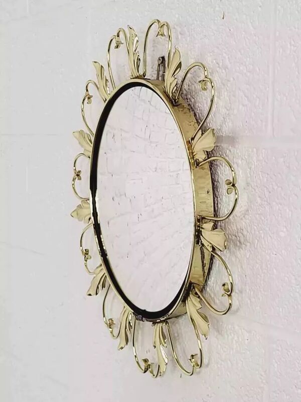 Miroir rond sur cadre laiton à volutes
