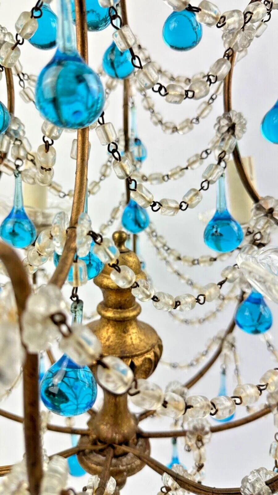 Italian chandelier with blue beads and gilded wood.