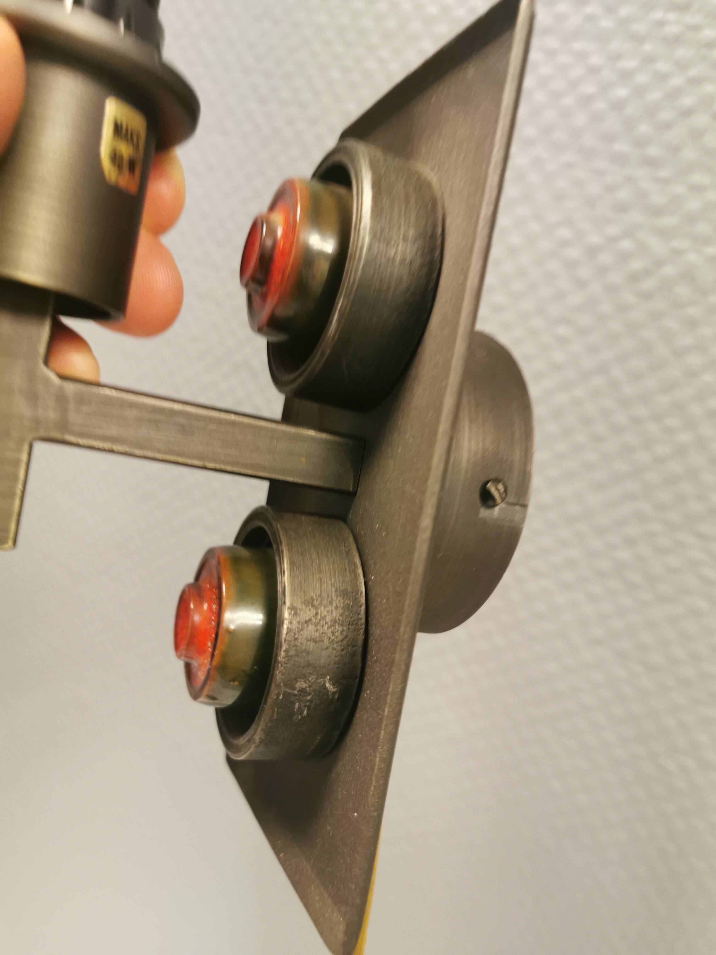 A set of Vitrika Denmark, cast iron wall lights with red details.