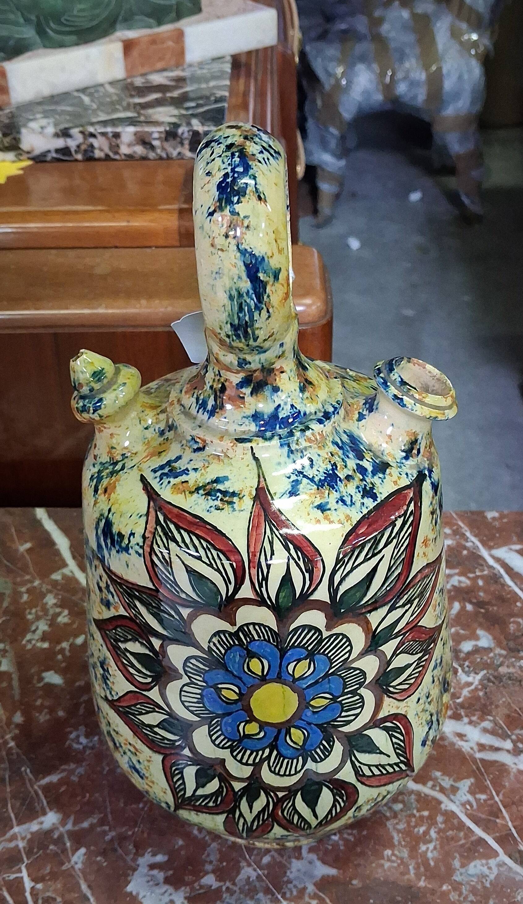 polychrome floral-decorated jug in glazed ceramic