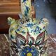 polychrome floral-decorated jug in glazed ceramic