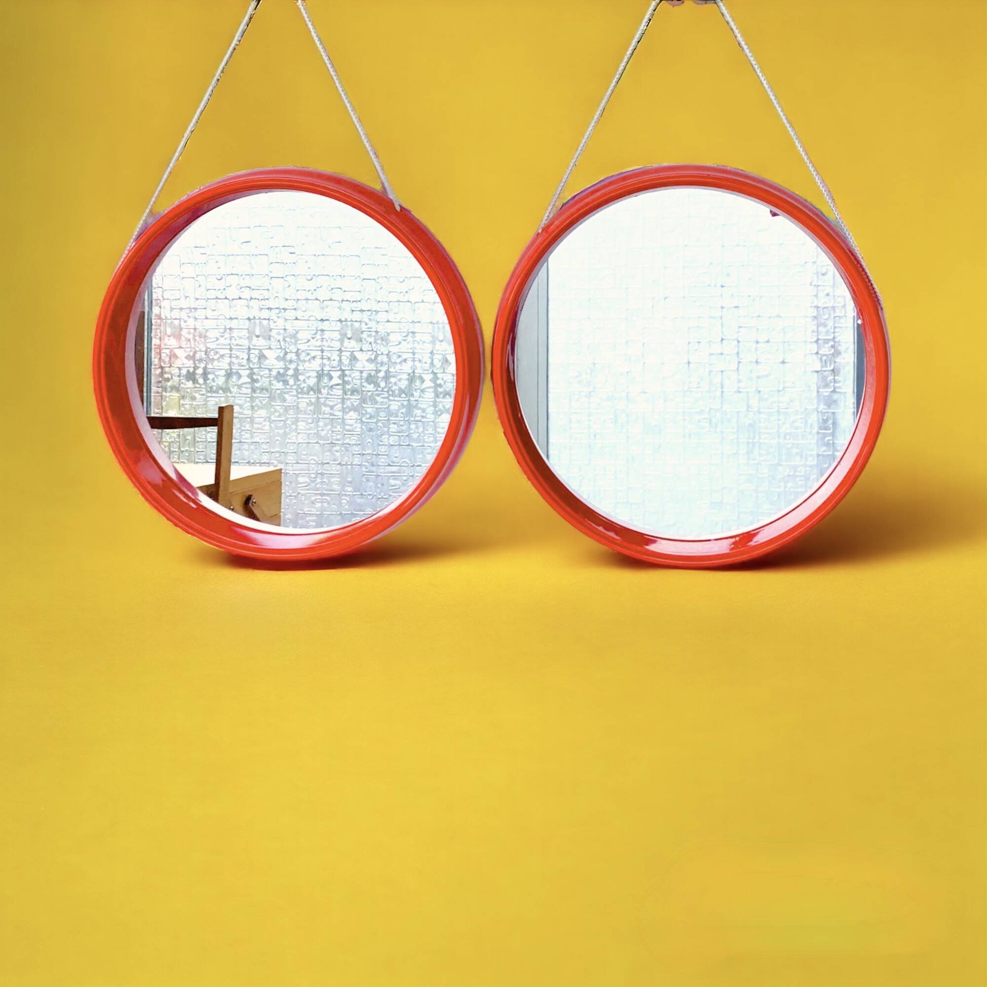 Pair of vintage round red plastic mirrors