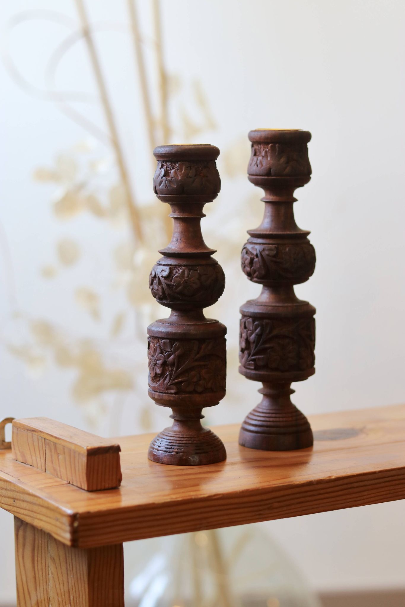 Pair of turned and carved wooden candlesticks