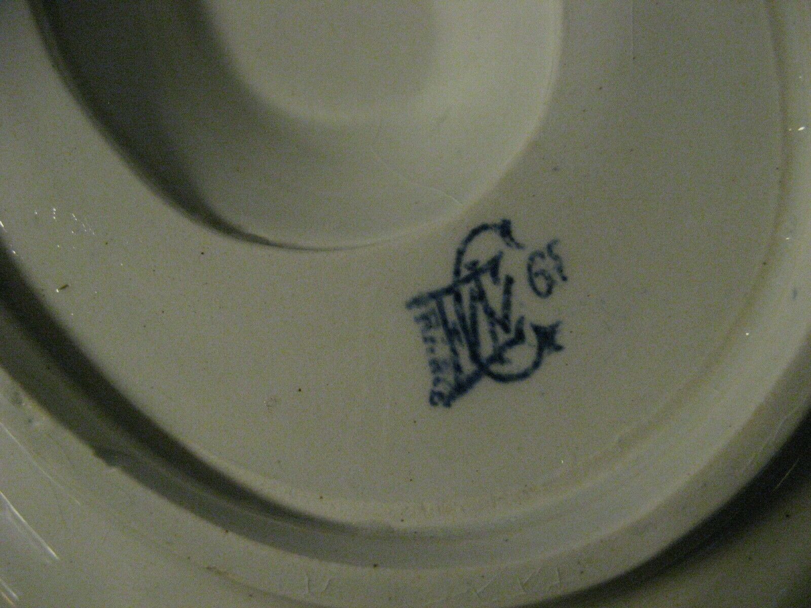 Saucière in Gien earthenware anse in the shape of a dolphin decoration garland 1900