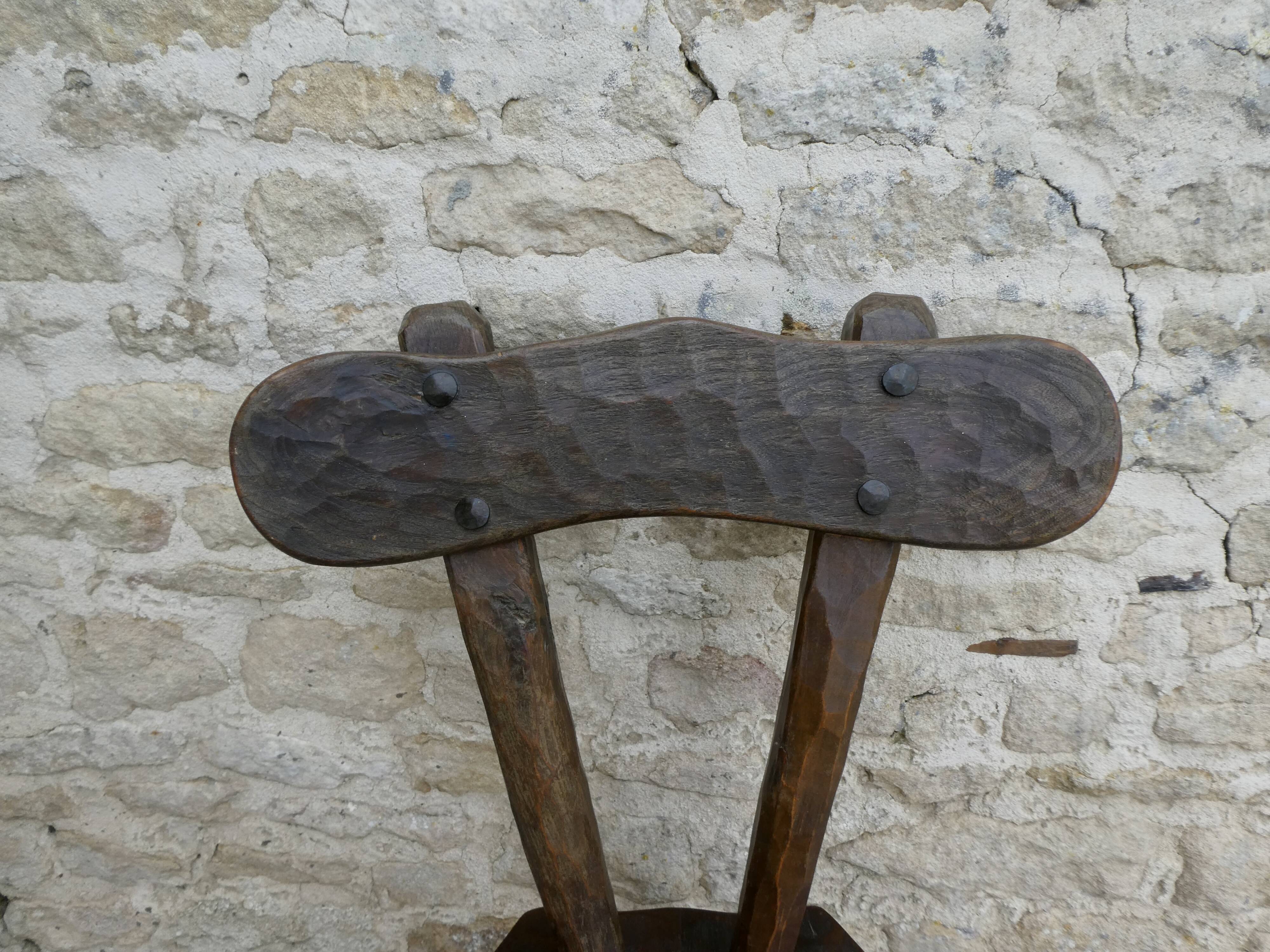 Brutalist chair in carved solid wood, around 1950.