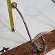 Antique wall-mounted coat rack in wood and metal with 4 hooks, 66 cm