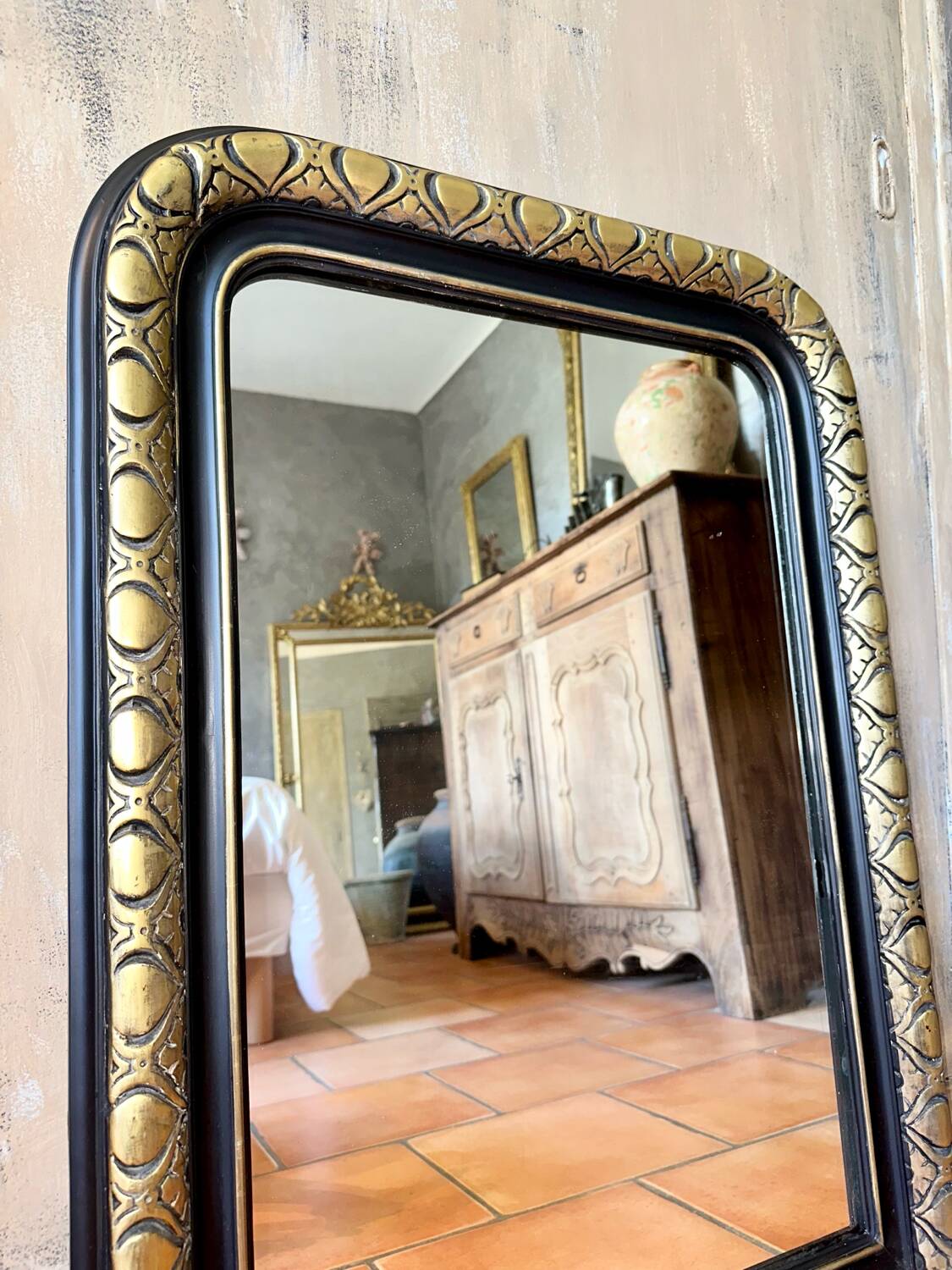 Louis-Philippe black and gold antique mirror from the 19th century