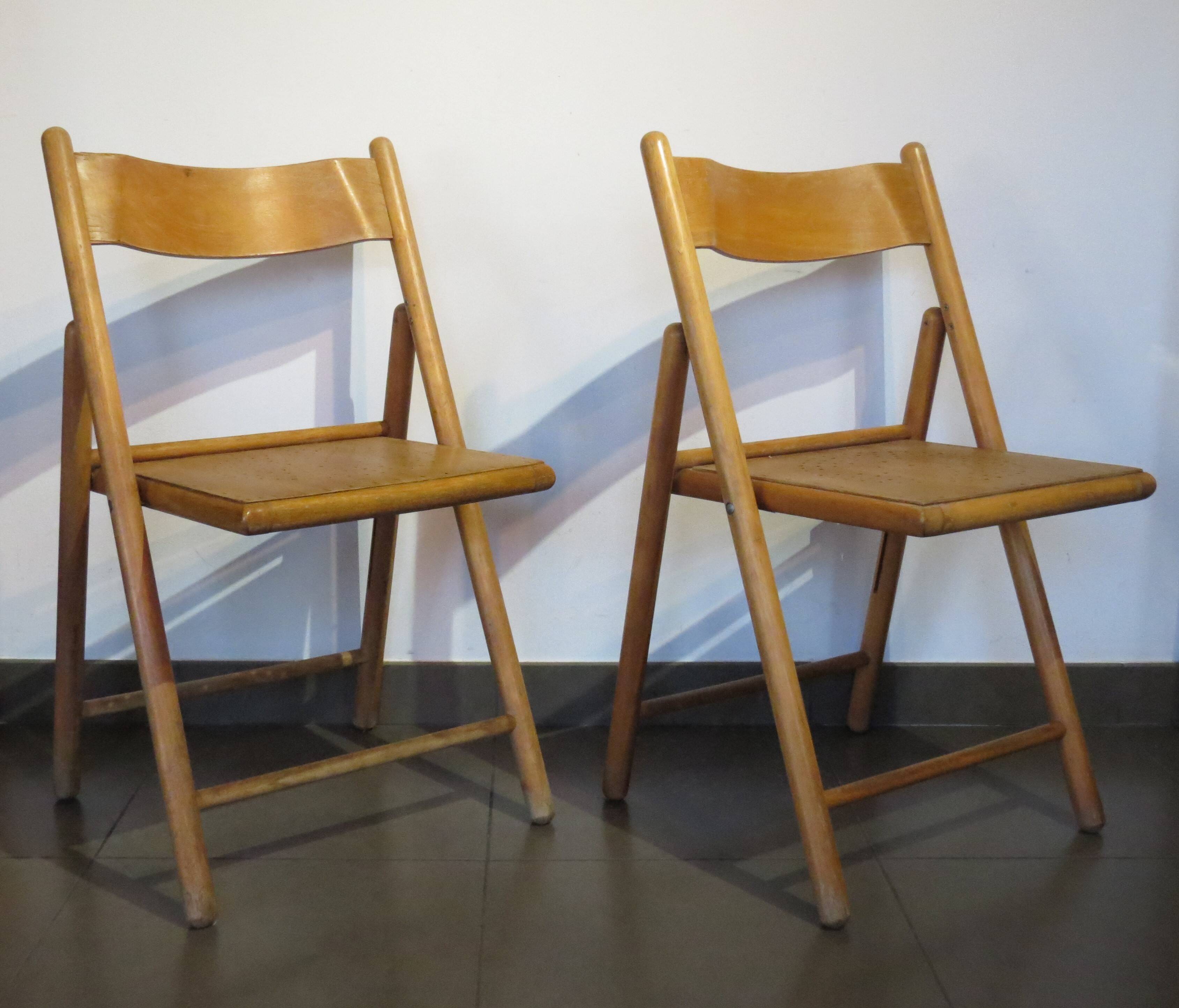 Pair of vintage wooden folding chairs with star pattern on seat