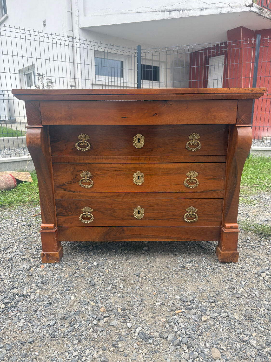 Restoration period walnut chest of drawers with a scroll handle
