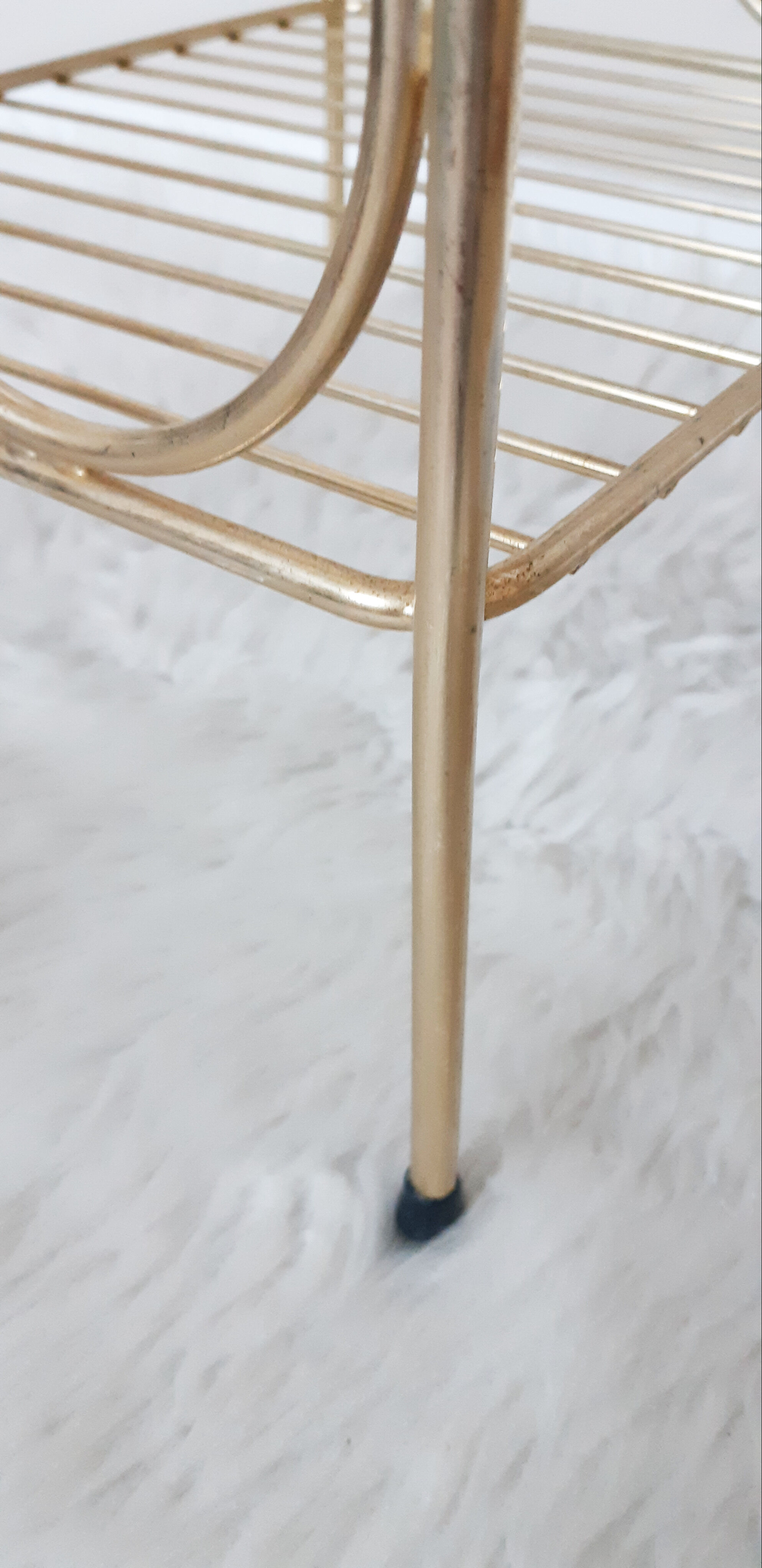 Side table with a golden magazine holder