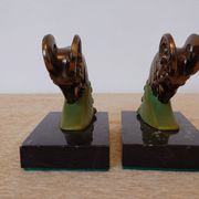 Art Deco pair of bookends with ram's heads, patinated metal and black marble.
