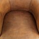 Sheepskin club armchair in a brown colour finished with decorative nails