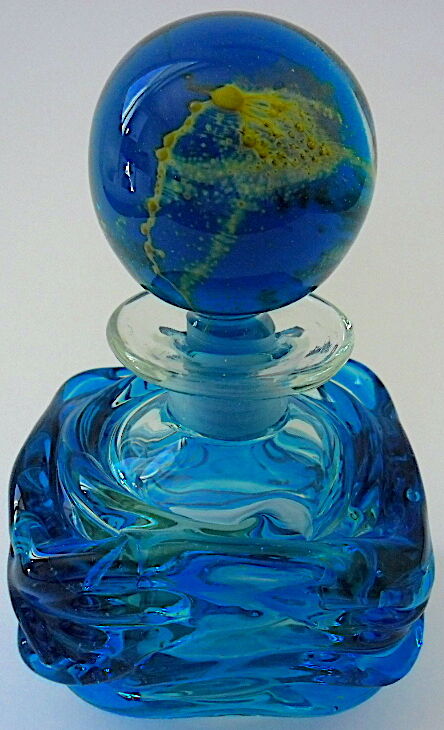 Blown blue glass bottle with inclusions