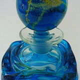 Blown blue glass bottle with inclusions