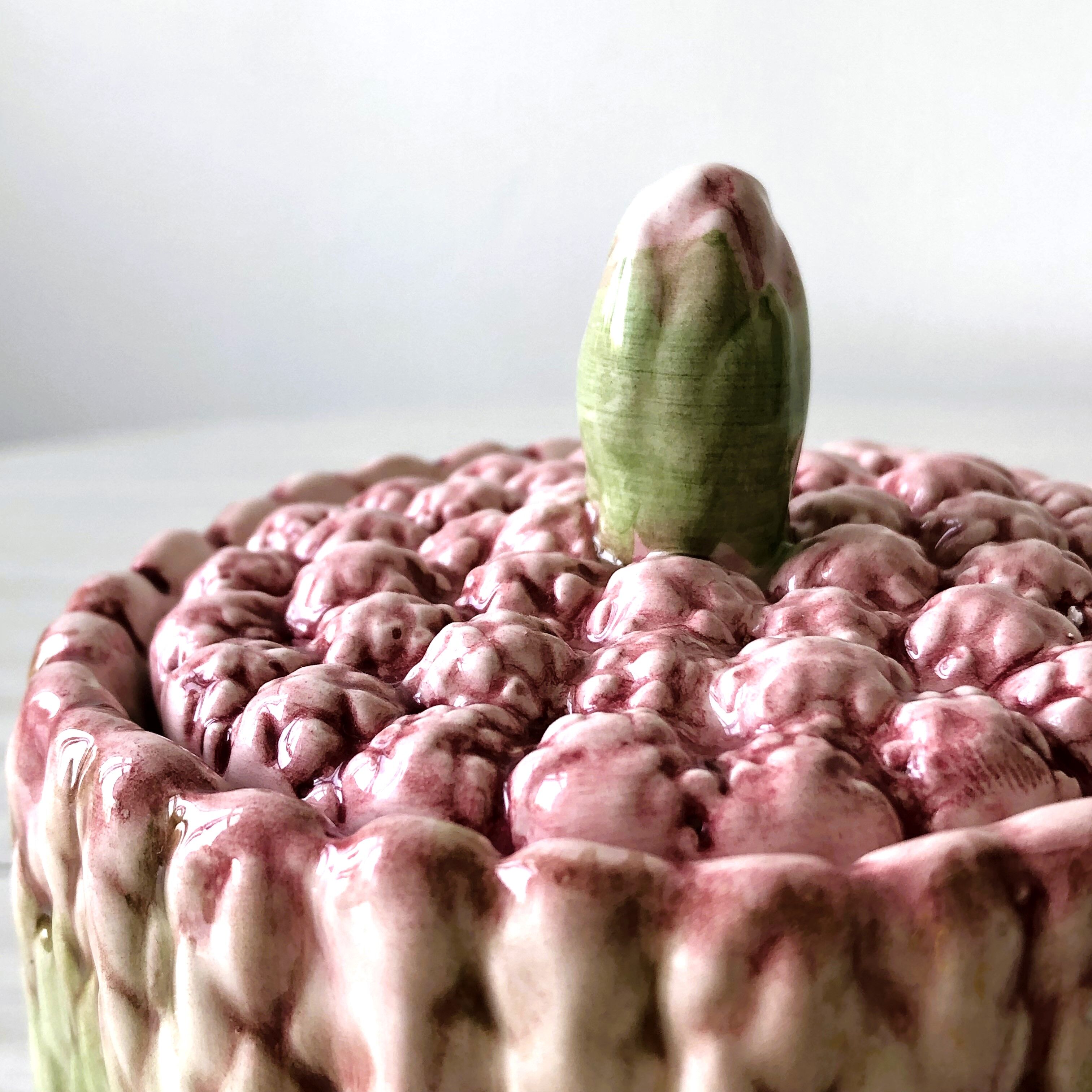 Old mustard pot and its slid in slurry decoration bunch of asparagus.