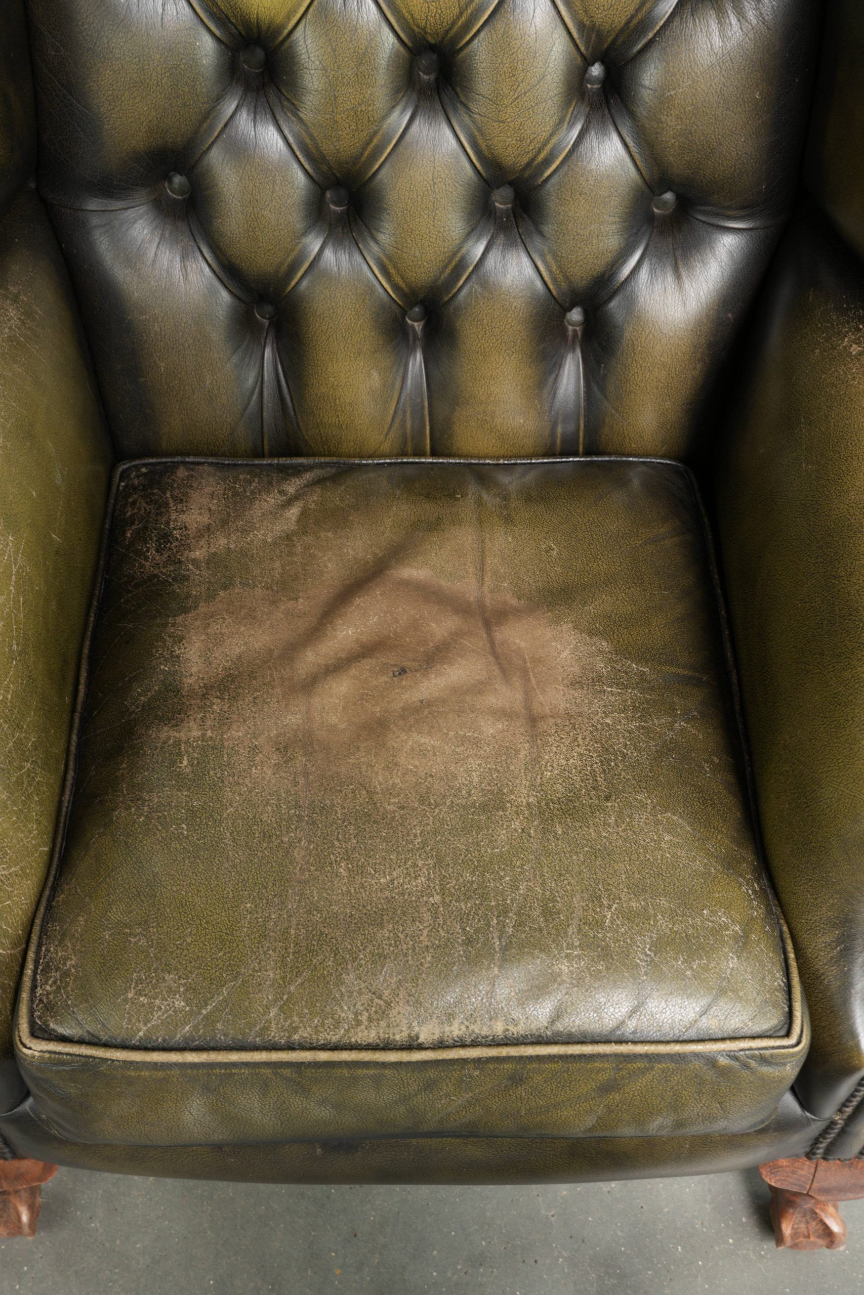 Vintage cowhide leather Chesterfield wingback armchair in a green colour