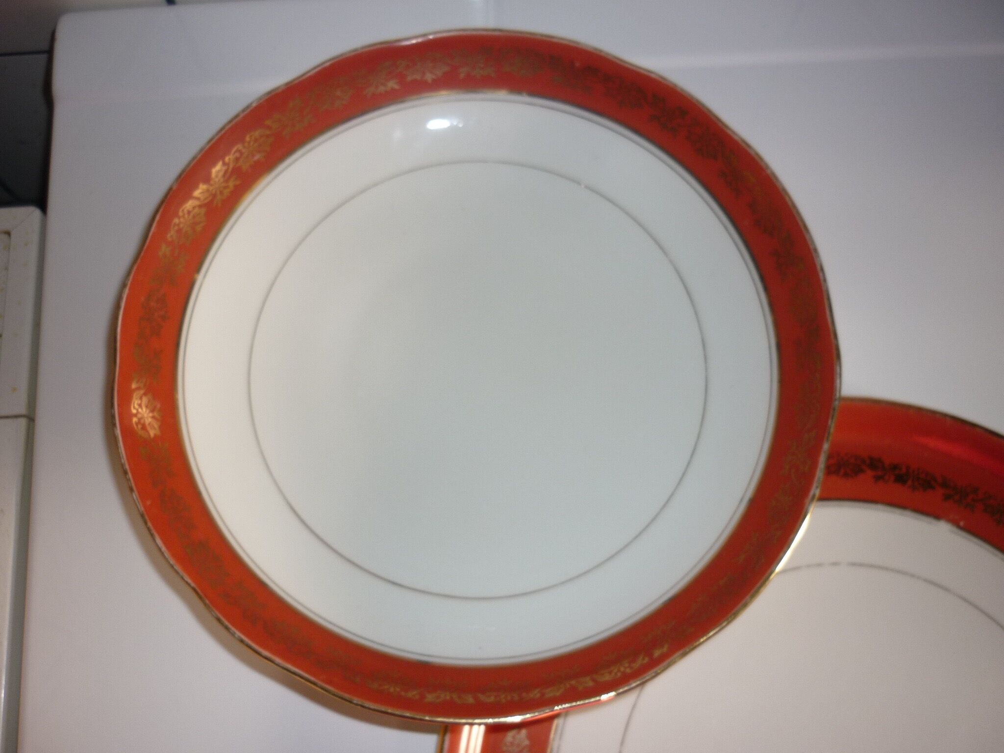 Plate and limoges porcelain dish with orange and gold trim