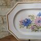 Rectangular earthenware dish with a glazed finish, decorated with a bouquet of flowers.