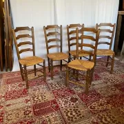 Set of 5 antique solid oak chairs with straw seats.