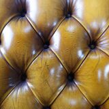 Pair of padded Chesterfield armchairs