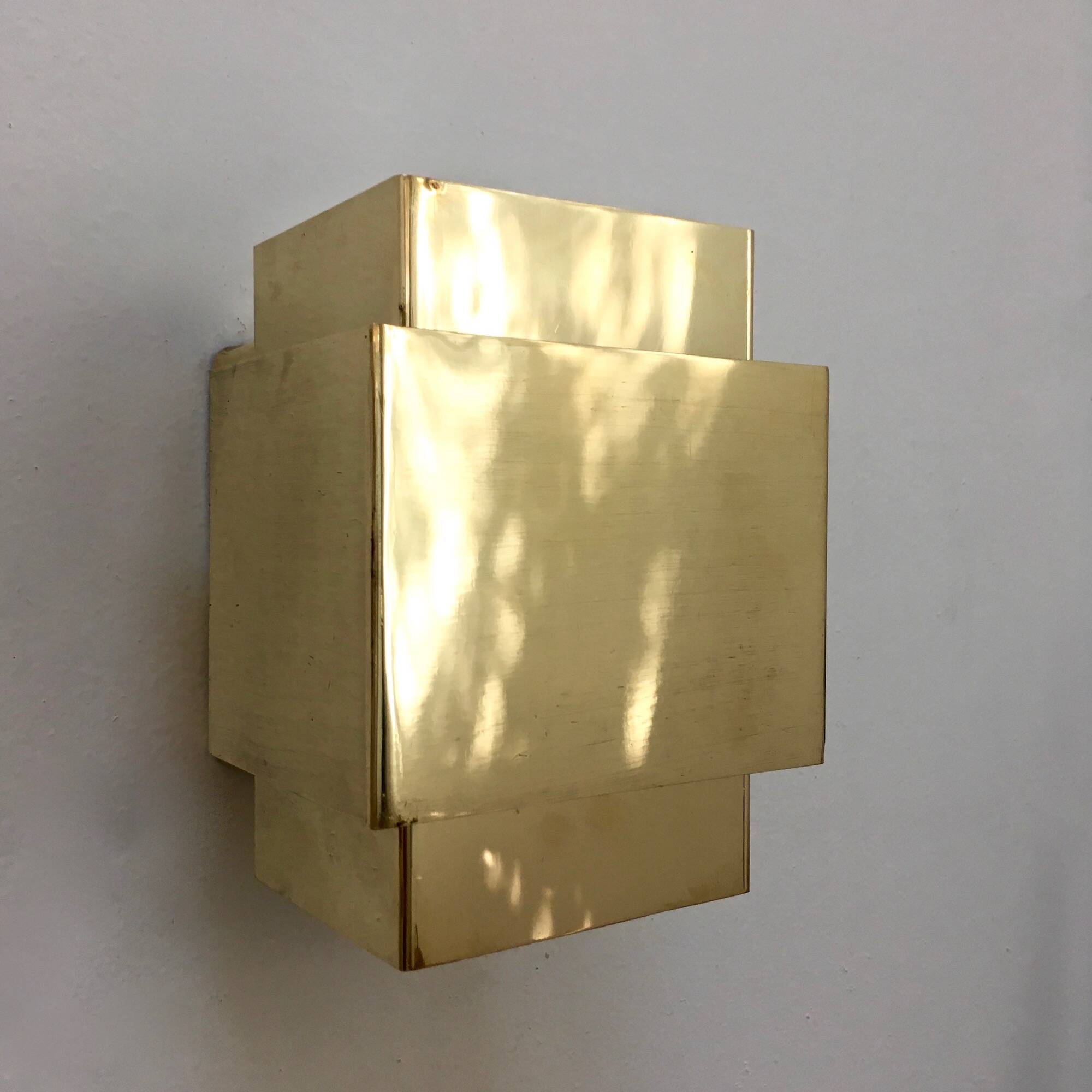 Cubical brass wall light