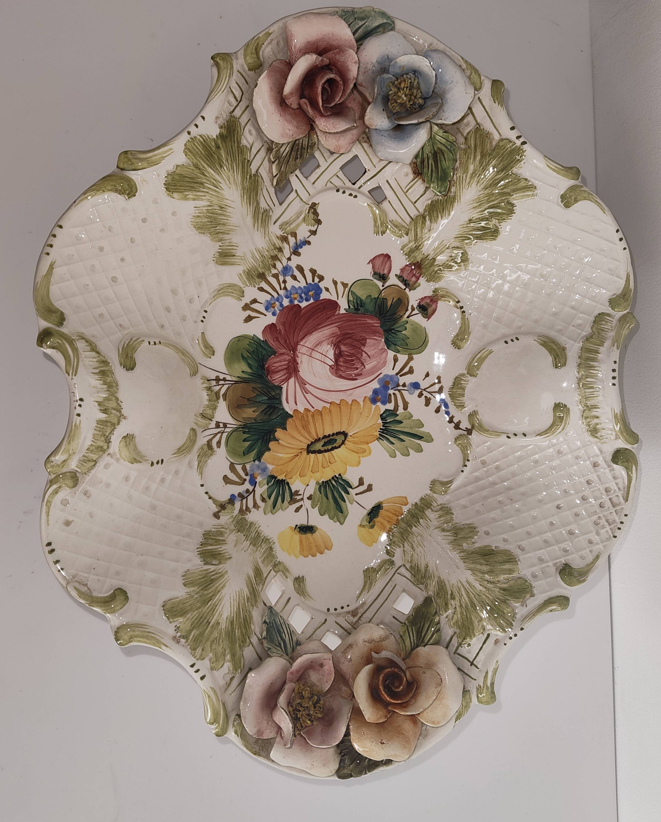 Openwork ceramic bowl with raised flower decoration in Italian style.