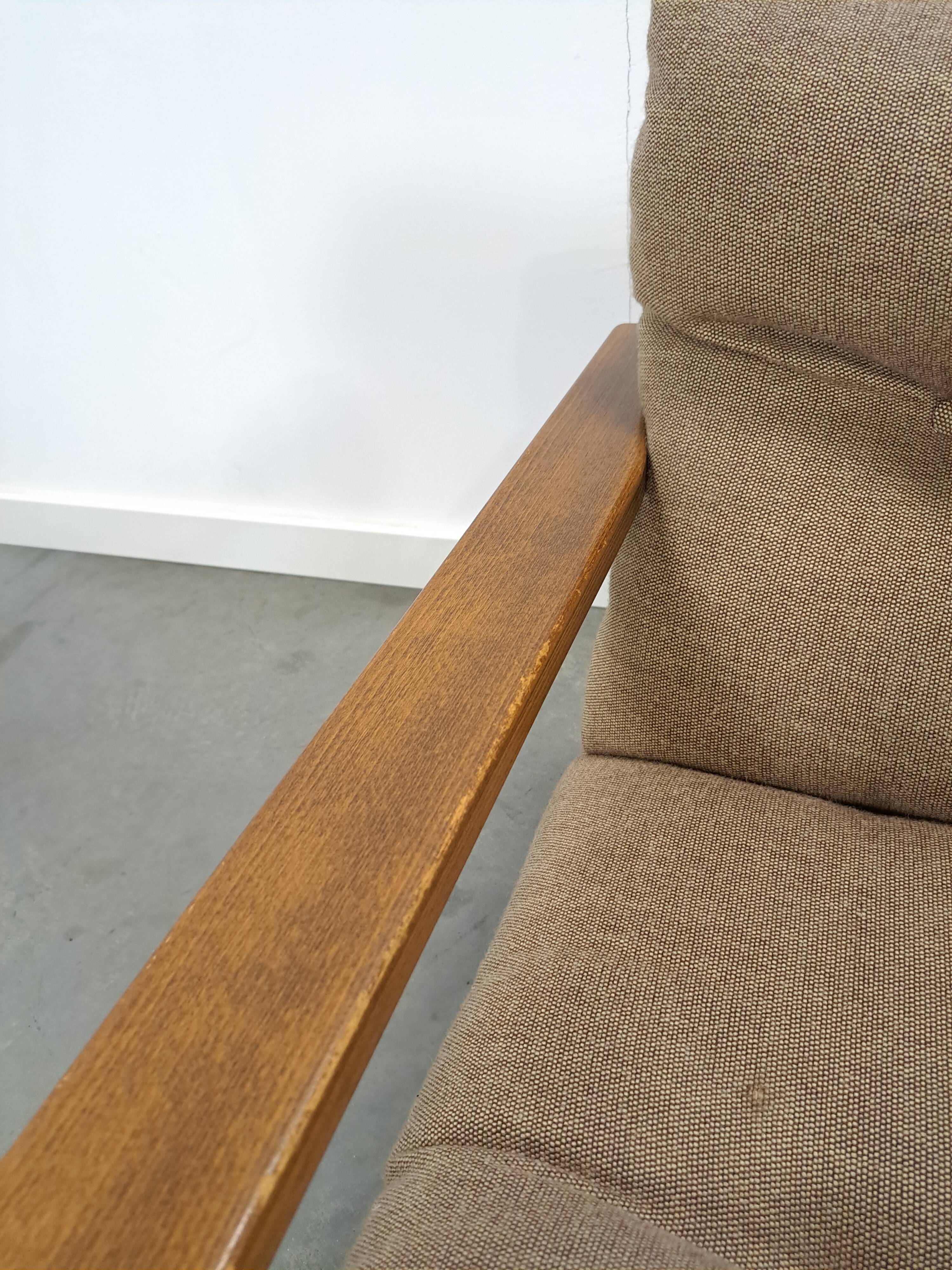 Brown-grey armchair with an oak frame.