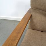 Brown-grey armchair with an oak frame.