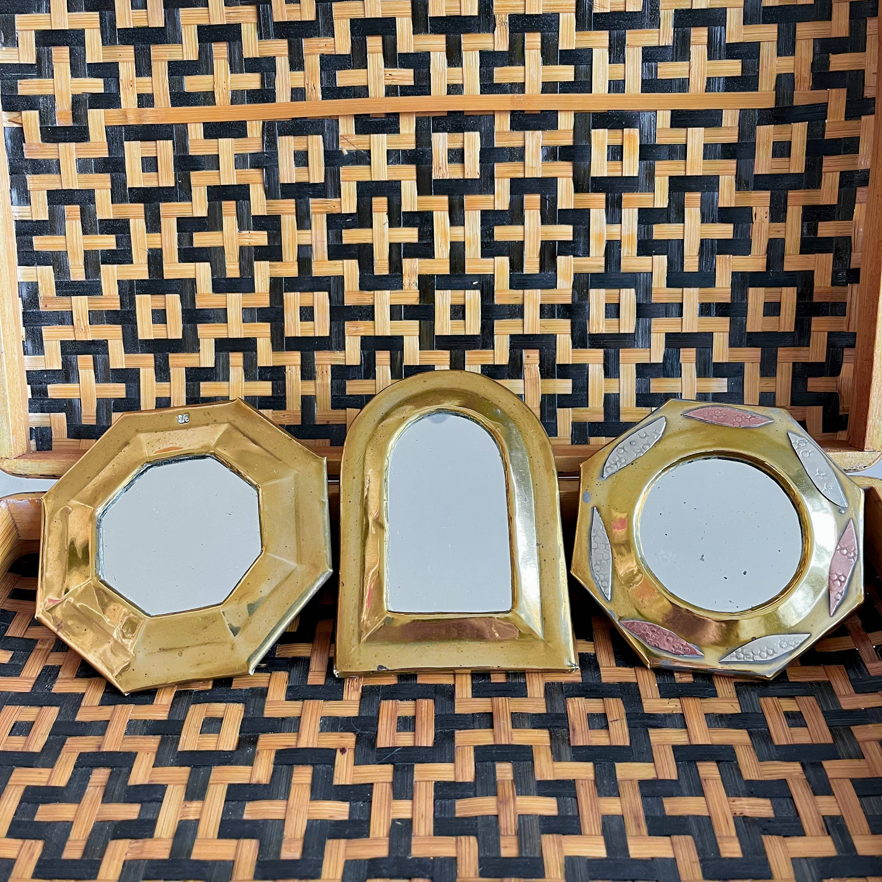 Trio of small brass mirrors