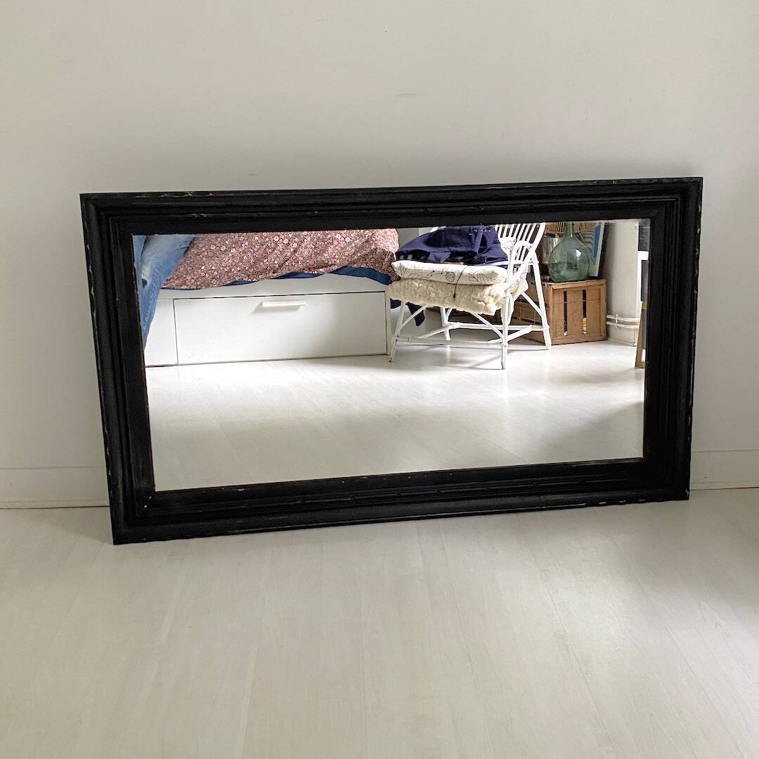 1950s mirror, matte black wood with a patina.